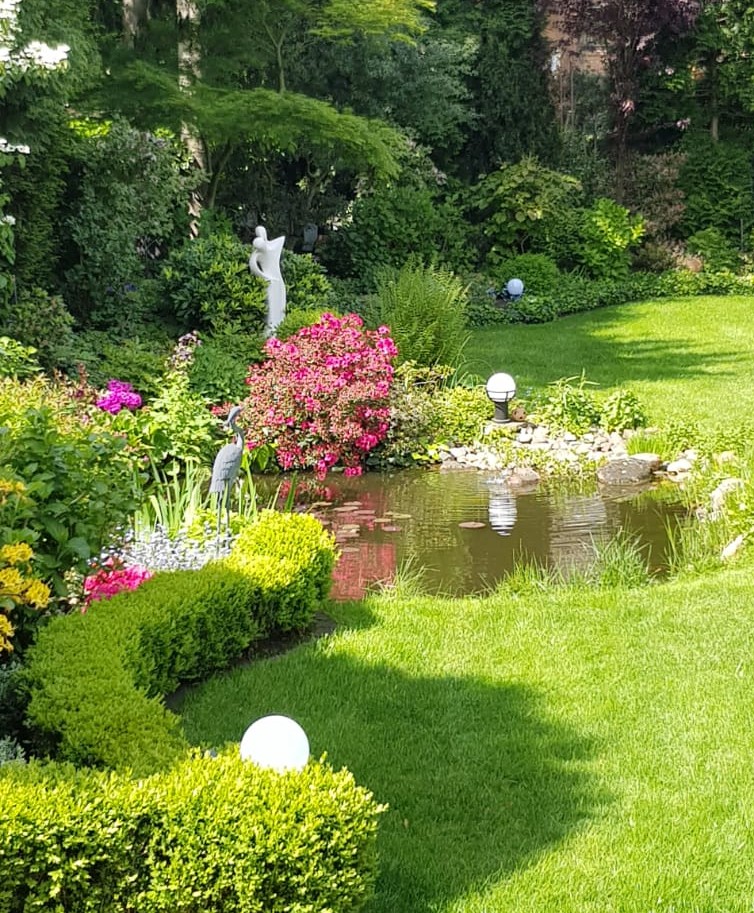Teichmotiv mit Entenfigur im Garten